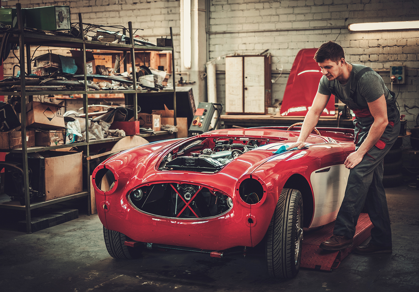 man restores classic car